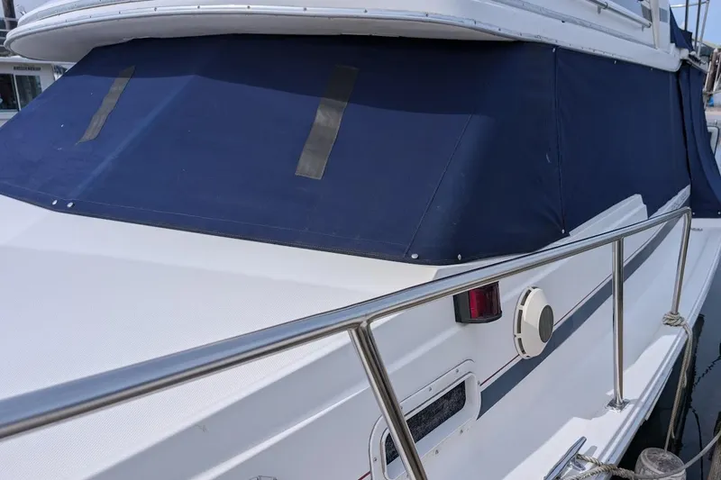 Slide: The Image of 1986 Bayliner 3270 Motoryacht with blue canvas cover and stainless steel railing. - 6