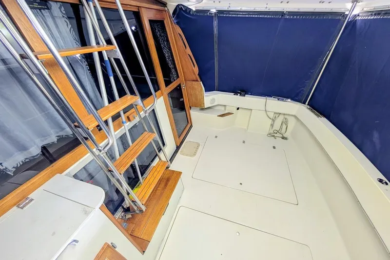 Slide: The Image of 1986 Bayliner 3270 Motoryacht interior with wooden ladder and blue curtains. - 8
