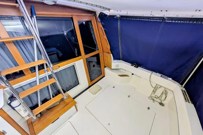 Slide: The Image of 1986 Bayliner 3270 Motoryacht interior with wooden ladder and blue curtains. - 9
