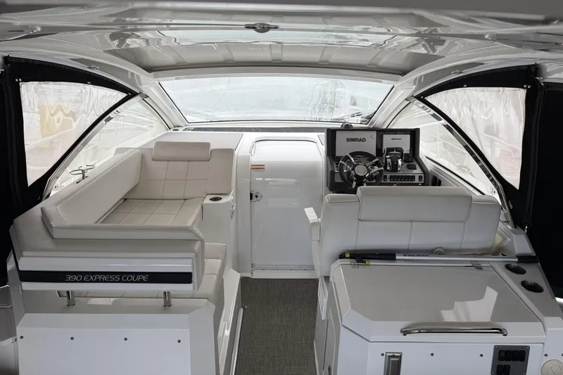 Slide: The Image of Interior of 2017 Cruisers Yachts 390 Express Coupe, featuring helm and seating area. - 12