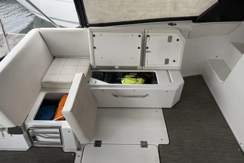Slide: The Image of 2017 Cruisers Yachts 390 Express Coupe interior storage compartments with seating. - 13