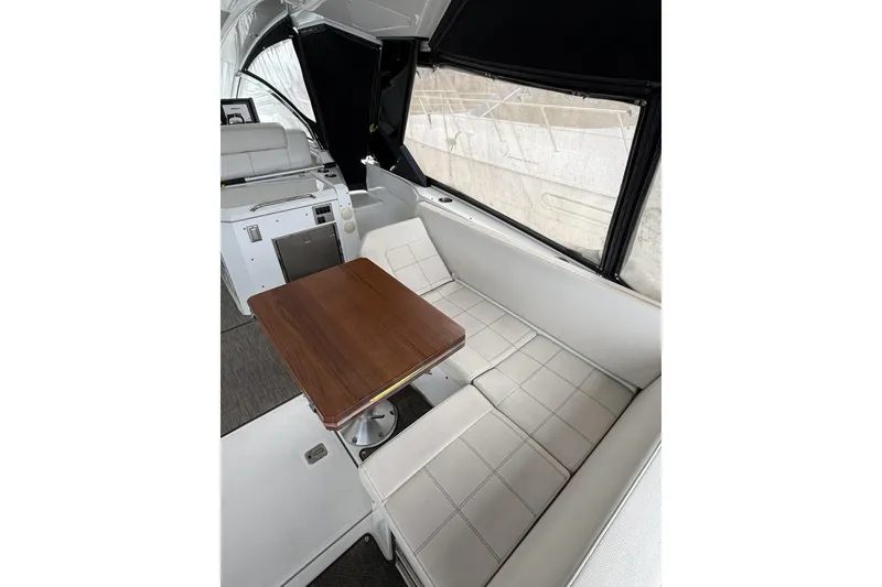 Slide: The Image of Interior of 2017 Cruisers Yachts 390 Express Coupe with seating and wooden table. - 15