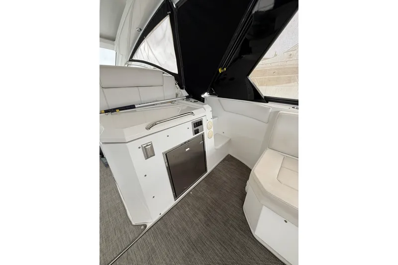Slide: The Image of 2017 Cruisers Yachts 390 Express Coupe interior with seating and kitchenette area. - 16