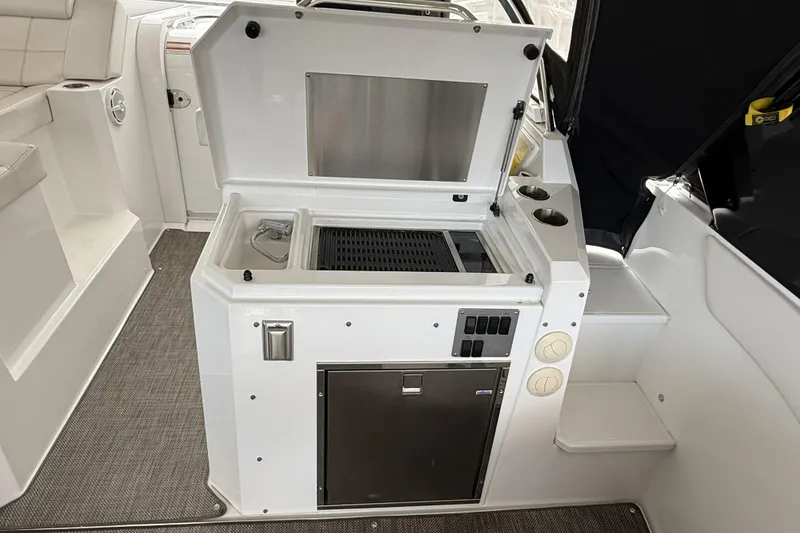 Slide: The Image of 2017 Cruisers Yachts 390 Express Coupe interior with kitchenette and seating area. - 17