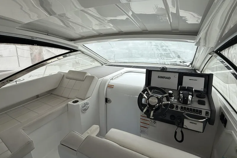 Slide: The Image of 2017 Cruisers Yachts 390 Express Coupe cockpit with modern navigation equipment and seating. - 18