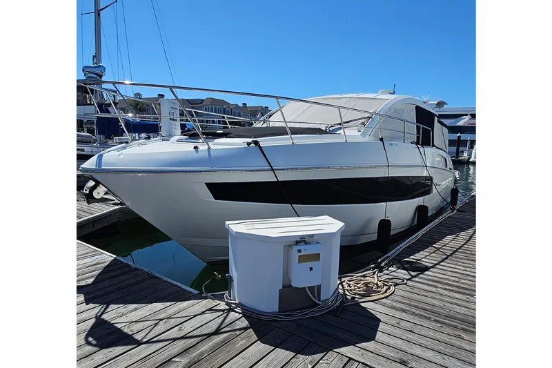 Slide: The Image of 2017 Cruisers Yachts 390 Express Coupe docked at marina under clear blue sky. - 2