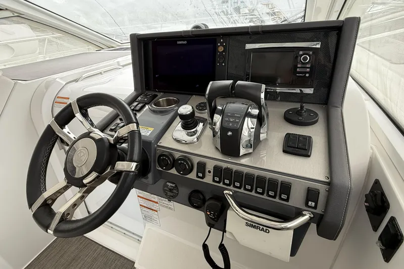 Slide: The Image of Helm of 2017 Cruisers Yachts 390 Express Coupe with steering wheel and control panel. - 20