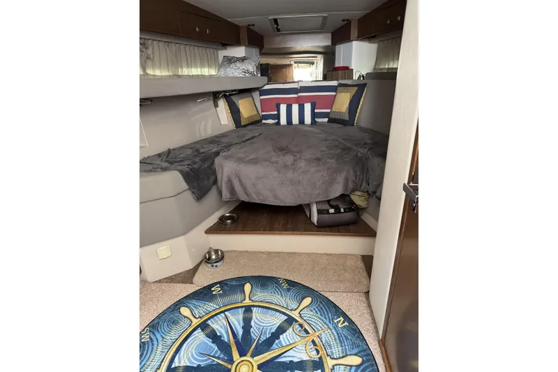 Slide: The Image of 2017 Cruisers Yachts 390 Express Coupe interior with cozy bed and nautical-themed decor. - 22