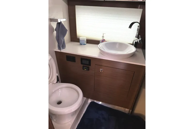 Slide: The Image of Bathroom interior of 2017 Cruisers Yachts 390 Express Coupe with modern sink and toilet. - 25