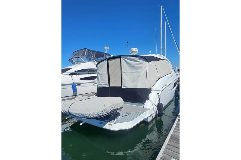 Slide: The Image of 2017 Cruisers Yachts 390 Express Coupe docked with protective covers. - 3