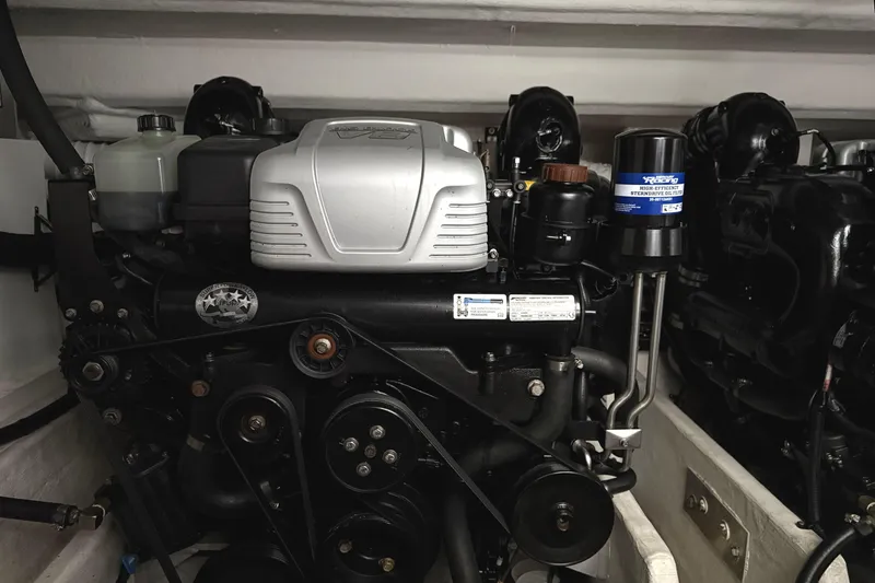 Slide: The Image of Engine compartment of a 2017 Cruisers Yachts 390 Express Coupe, showcasing mechanical components. - 30