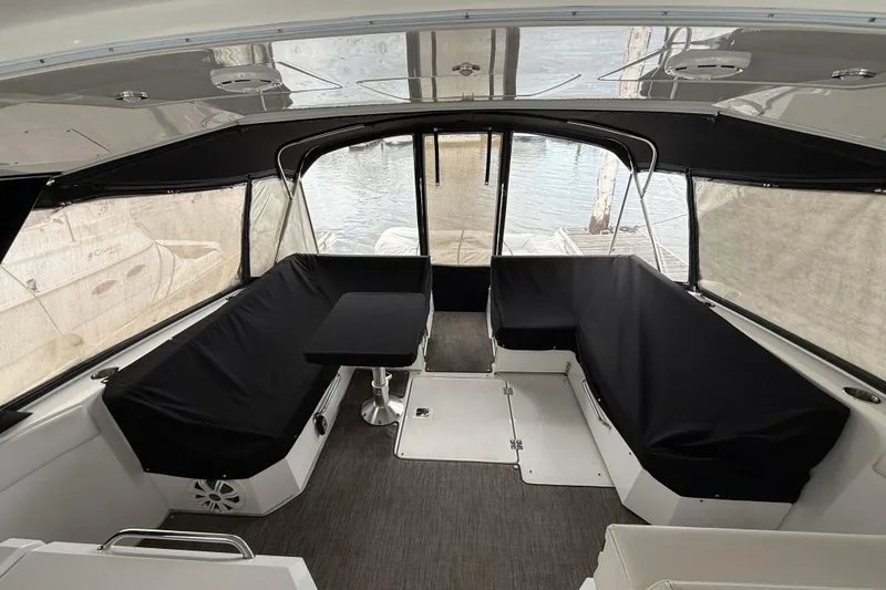 Slide: The Image of 2017 Cruisers Yachts 390 Express Coupe interior with covered seating and table. - 6