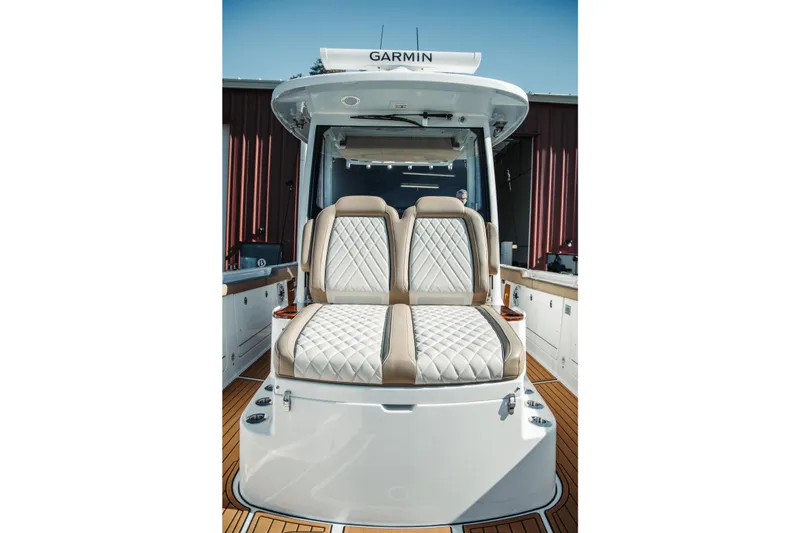 Slide: The Image of 2024 Everglades 315 Center Console boat with luxurious seating and Garmin equipment. - 14