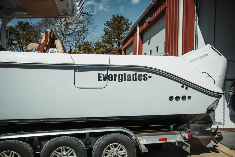 Slide: The Image of 2024 Everglades 315 Center Console boat on trailer, side view. - 2