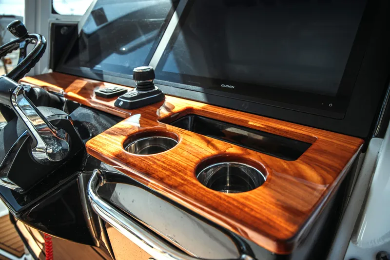 Slide: The Image of 2024 Everglades 315 Center Console helm with wood finish. - 22