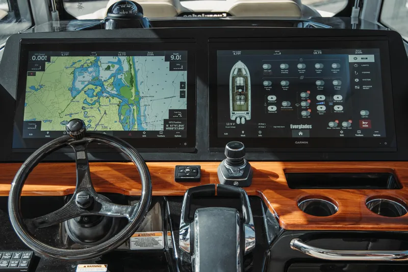 Slide: The Image of 2024 Everglades 315 Center Console dashboard with dual Garmin displays and navigation controls. - 29