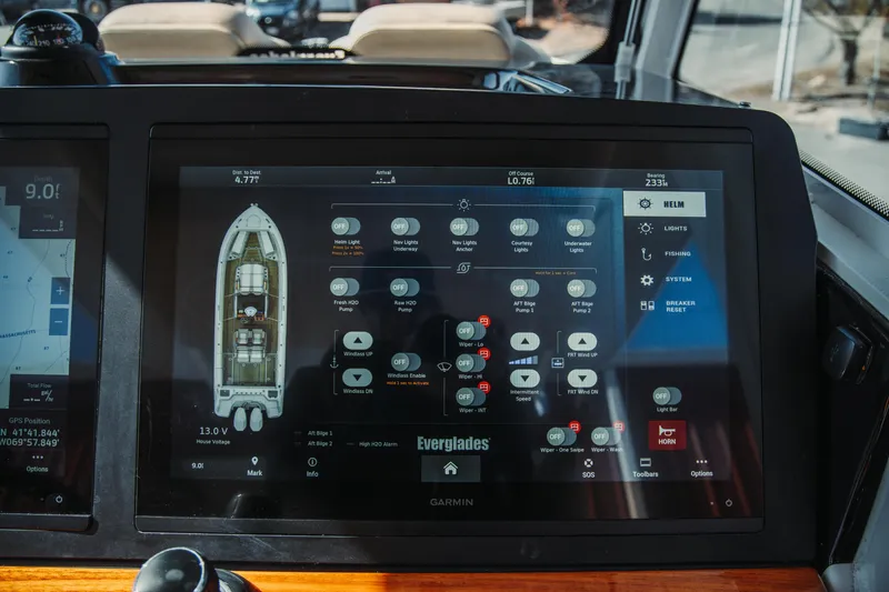 Slide: The Image of Touchscreen control panel on 2024 Everglades 315 Center Console boat, displaying navigation and system settings. - 30