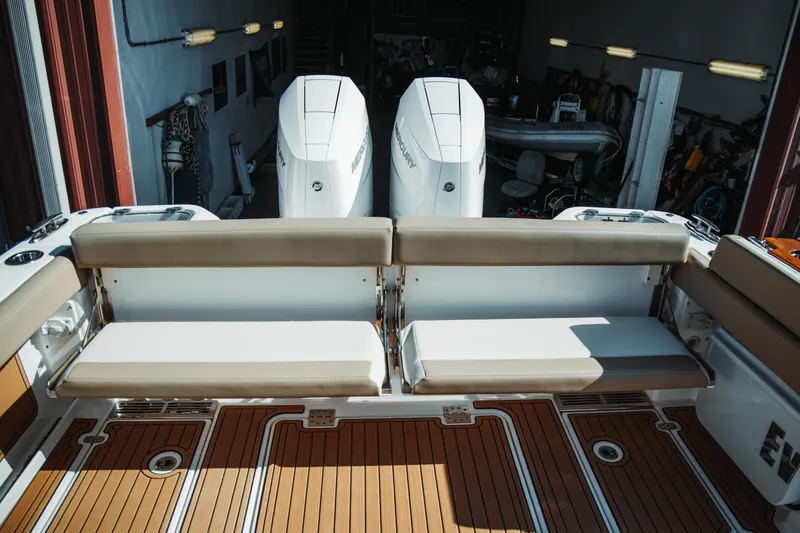 Slide: The Image of 2024 Everglades 315 Center Console boat with twin Mercury engines and cushioned seating. - 32