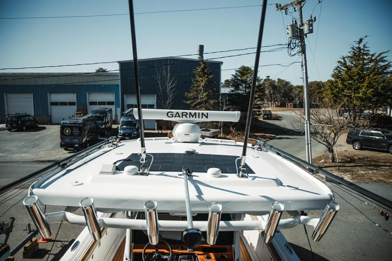 Slide: The Image of 2024 Everglades 315 Center Console boat with Garmin equipment in a marina setting. - 35
