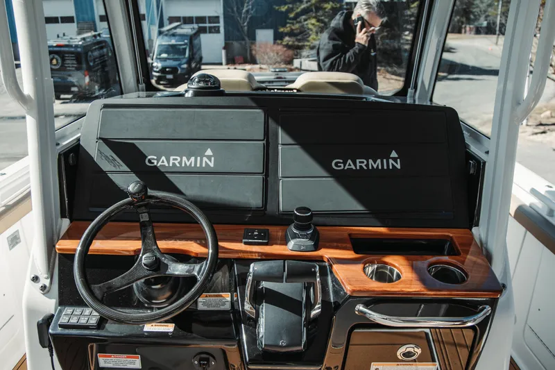 Slide: The Image of 2024 Everglades 315 Center Console boat dashboard with Garmin navigation system. - 39