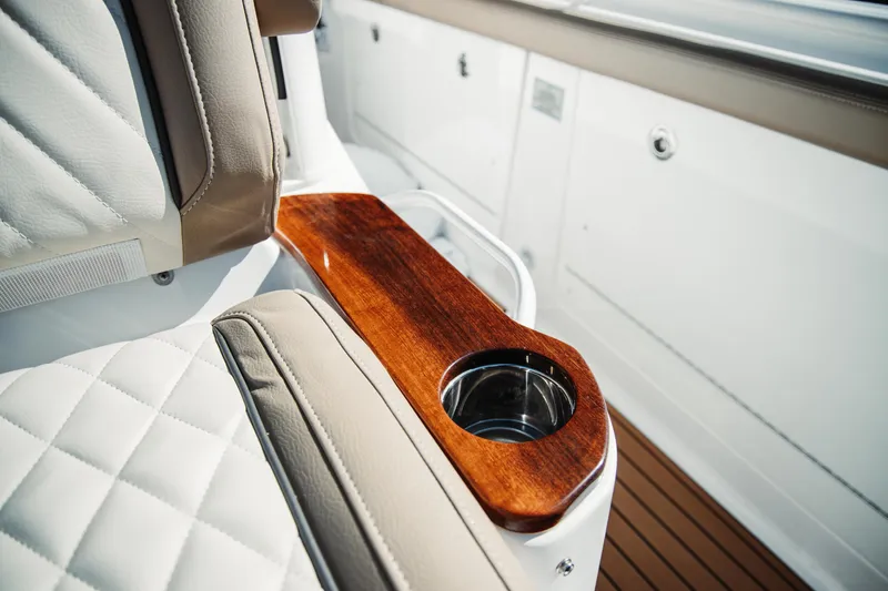 Slide: The Image of Luxurious seating detail on 2024 Everglades 315 Center Console with wood trim and cup holder. - 44