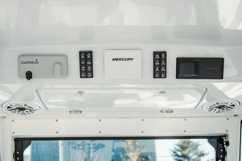 Slide: The Image of 2024 Everglades 315 Center Console dashboard with Garmin, Mercury, and Fusion controls. - 45