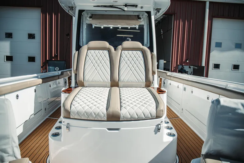 Slide: The Image of 2024 Everglades 315 Center Console boat with luxurious seating and sleek design. - 49