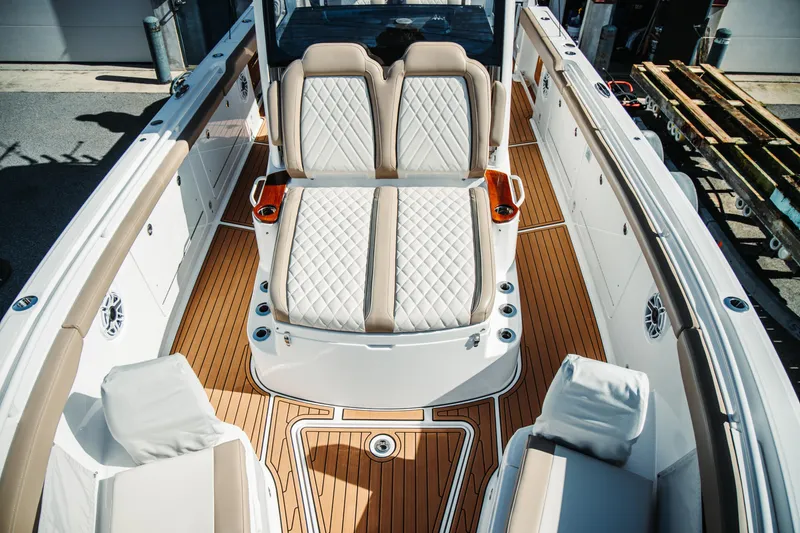 Slide: The Image of 2024 Everglades 315 Center Console boat interior with luxurious seating and teak flooring. - 50