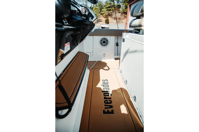 Slide: The Image of 2024 Everglades 315 Center Console interior with branded flooring and speaker system. - 51