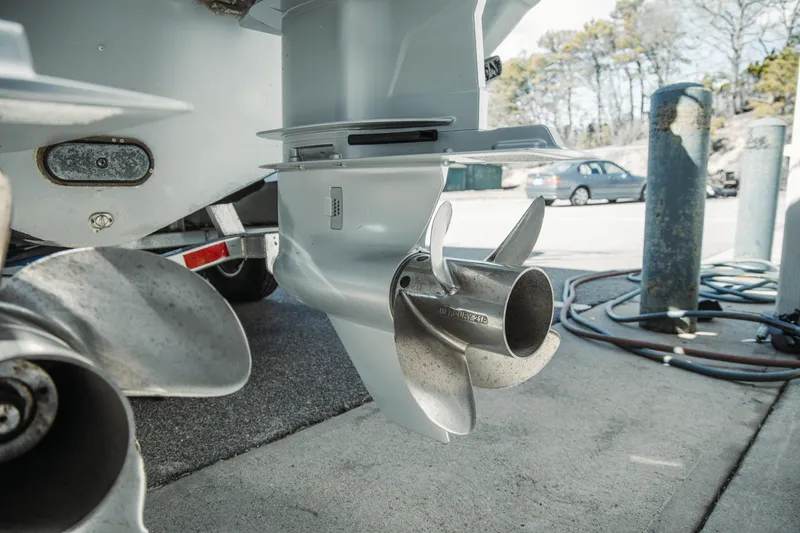 Slide: The Image of 2024 Everglades 315 Center Console boat propellers on a trailer, close-up view. - 53