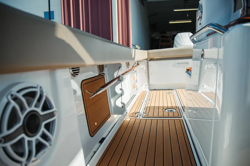 Slide: The Image of 2024 Everglades 315 Center Console boat interior with teak flooring and modern design. - 56