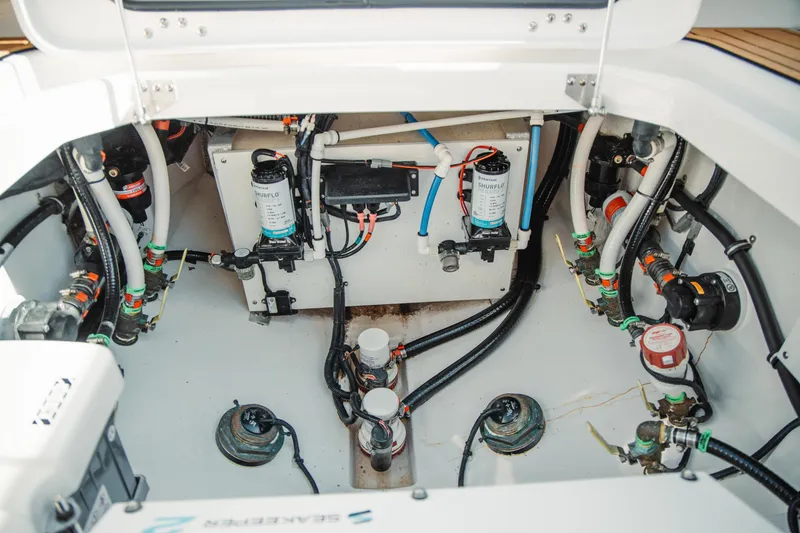 Slide: The Image of Engine compartment of 2024 Everglades 315 Center Console boat, showcasing intricate wiring and components. - 58