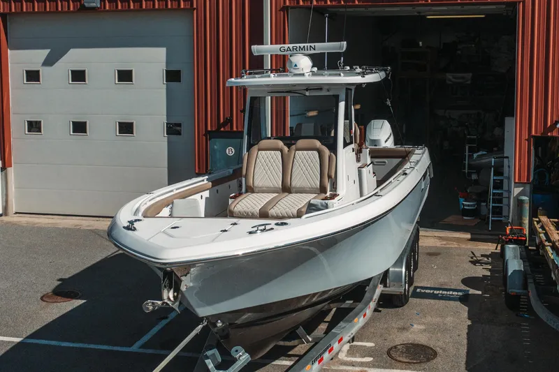 Slide: The Image of 2024 Everglades 315 Center Console boat on trailer outside garage. - 6