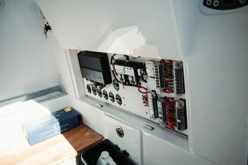 Slide: The Image of Electrical panel inside 2024 Everglades 315 Center Console boat, showcasing wiring and components. - 63