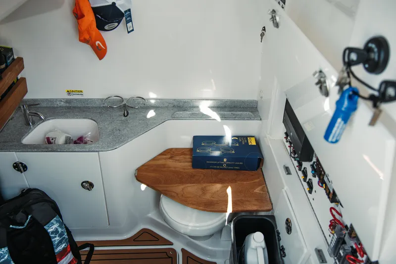 Slide: The Image of 2024 Everglades 315 Center Console interior with sink, storage, and control panel. - 64