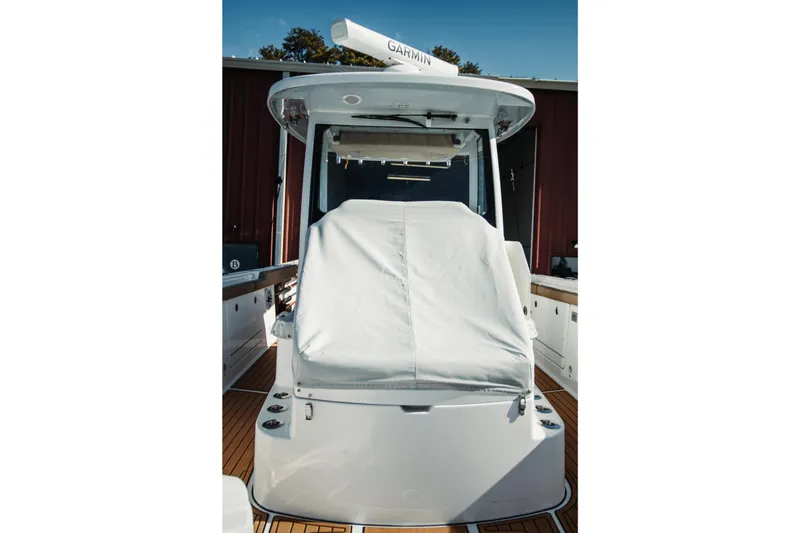 Slide: The Image of 2024 Everglades 315 Center Console boat with covered seating and Garmin equipment. - 65