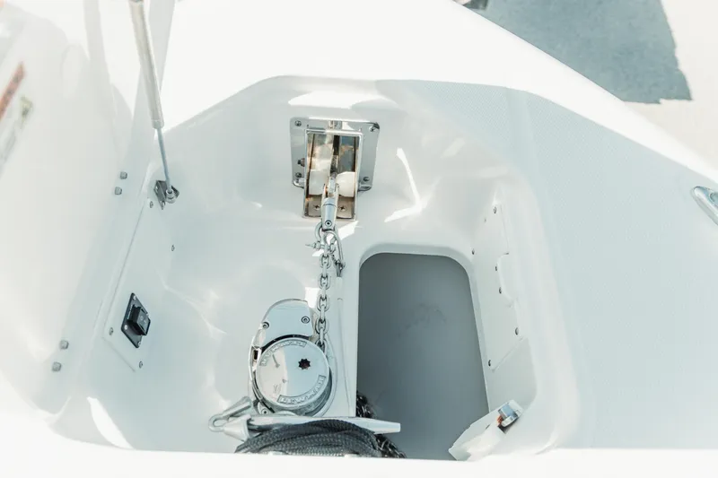 Slide: The Image of Anchor compartment of 2024 Everglades 315 Center Console boat, featuring chain and winch. - 66