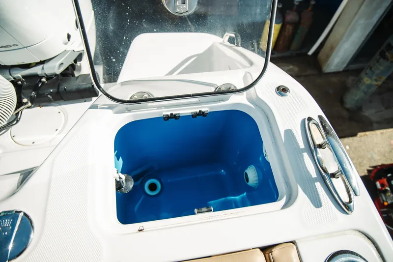 Slide: The Image of 2024 Everglades 315 Center Console livewell with open lid, showcasing interior features. - 68