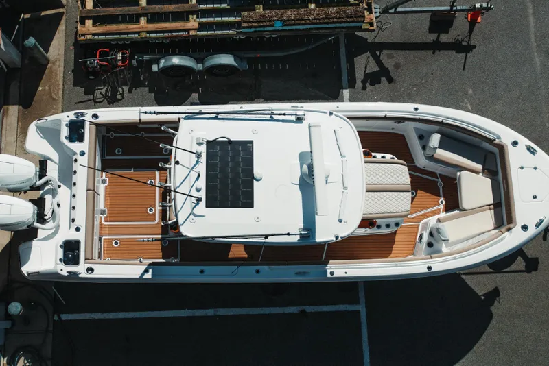 Slide: The Image of 2024 Everglades 315 Center Console boat, aerial view, docked with wooden deck and seating. - 7