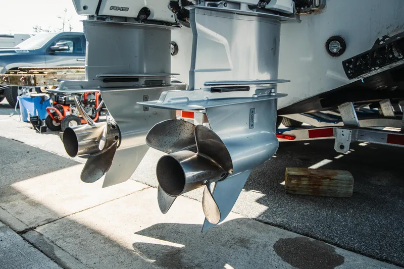 Slide: The Image of Twin outboard motors on a 2024 Everglades 315 Center Console boat, parked on a trailer. - 70