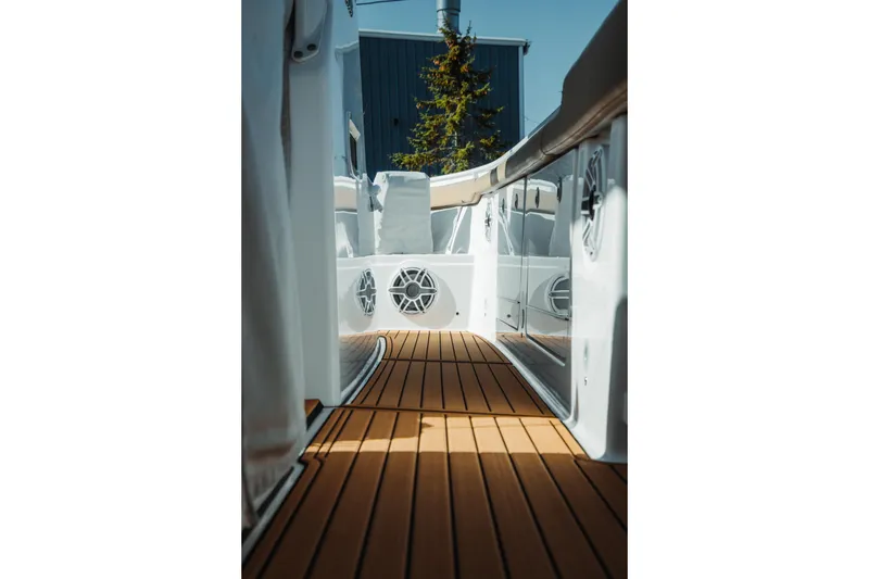 Slide: The Image of 2024 Everglades 315 Center Console boat with teak deck and sleek white interior. - 71