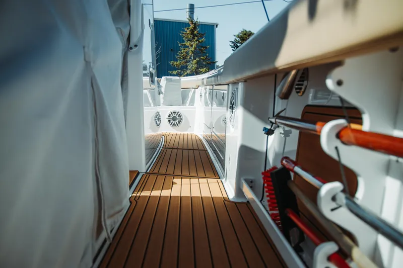 Slide: The Image of 2024 Everglades 315 Center Console boat interior with teak flooring and storage compartments. - 72