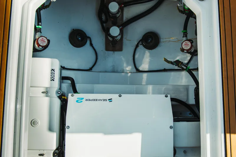 Slide: The Image of Engine compartment of 2024 Everglades 315 Center Console boat, showcasing Seakeeper system. - 77