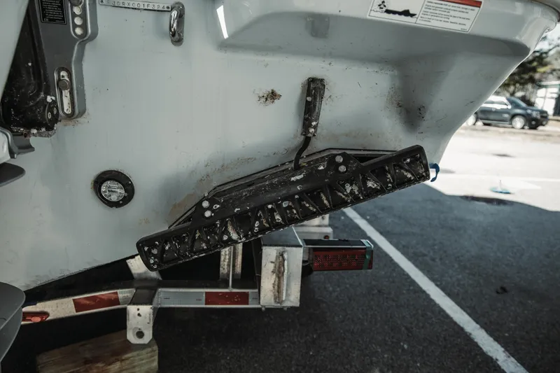 Slide: The Image of 2024 Everglades 315 Center Console boat on trailer, showing rear hull details. - 83