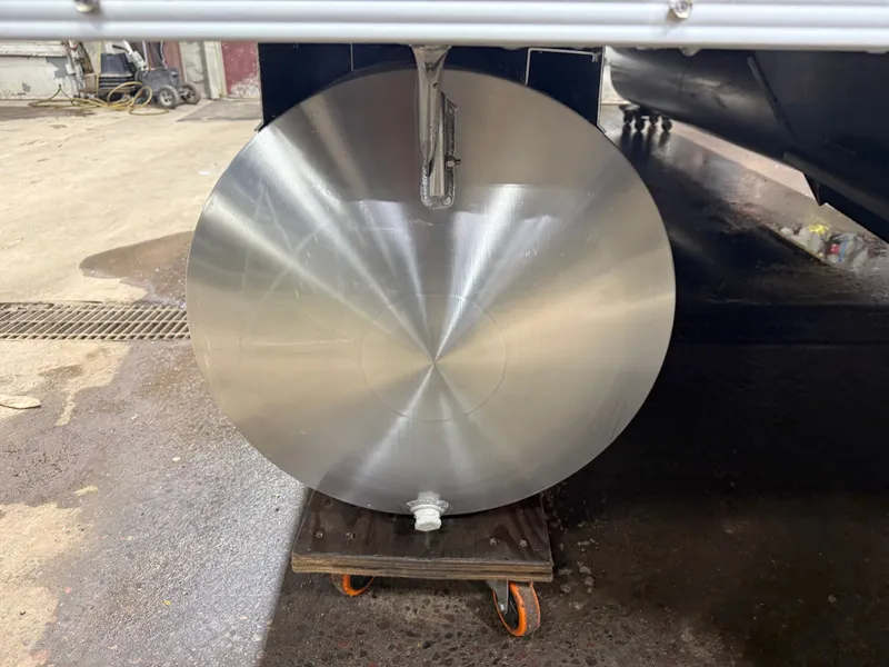 Slide: The Image of Close-up of a shiny metal cylinder on a wheeled platform. - 42