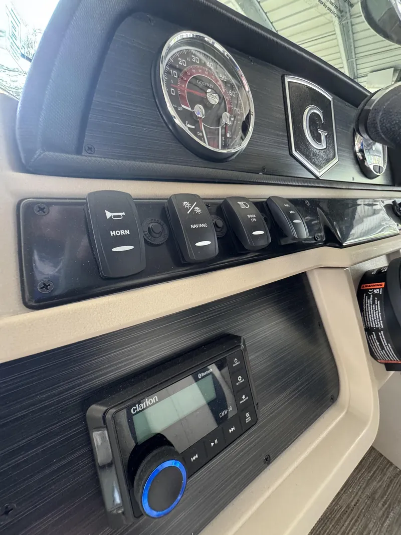 Slide: The Image of Dashboard of 2026 Godfrey SW 2286 Fish Stern with controls and radio. - 45