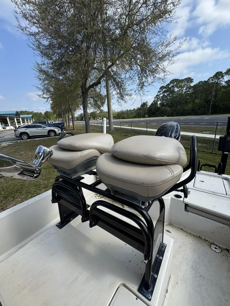 Slide: The Image of 2020 Blue Wave 2200 PureBay boat with cushioned seats outdoors. - 23