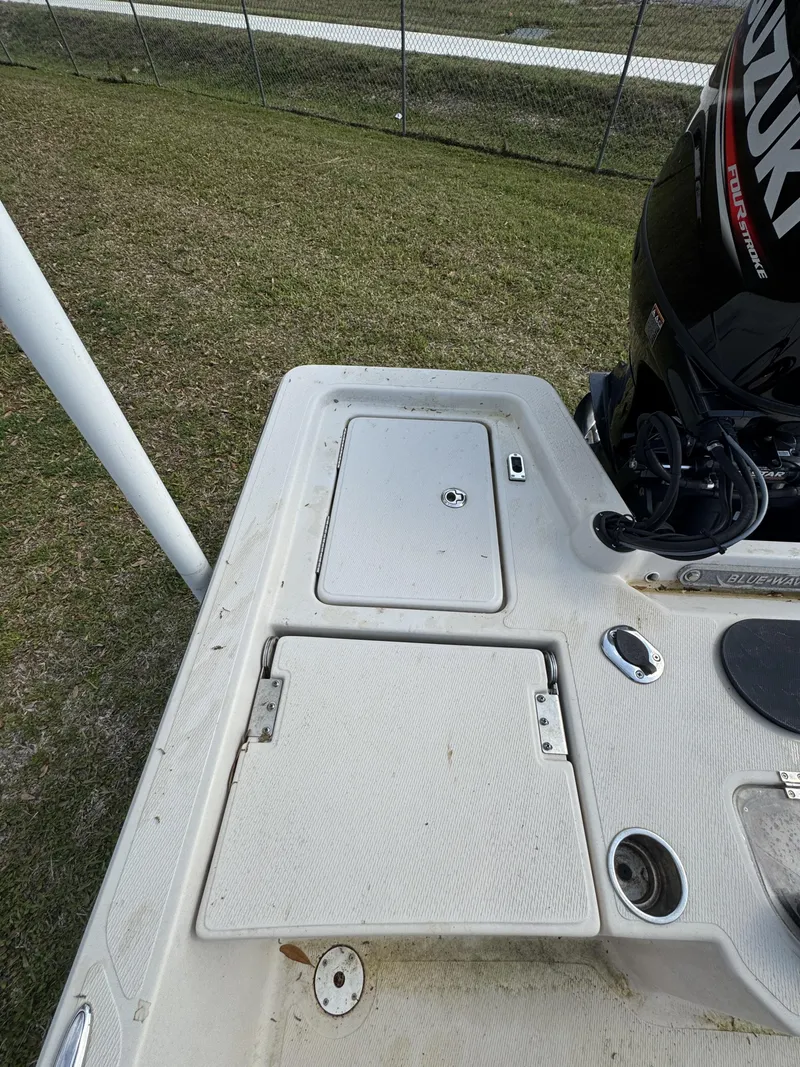 Slide: The Image of 2020 Blue Wave 2200 PureBay boat deck with Suzuki outboard motor. - 24