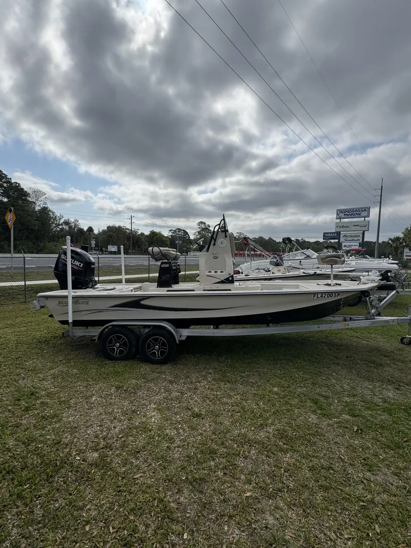 Slide: The Image of 2020 Blue Wave 2200 PureBay boat on trailer, cloudy sky. - 34