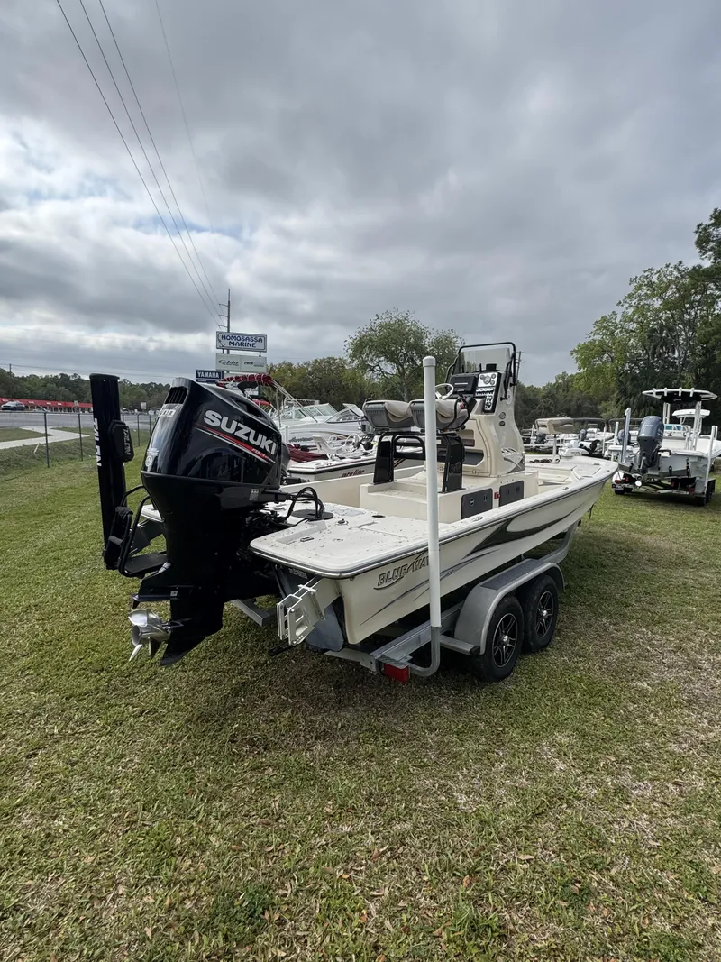 Slide: The Image of 2020 Blue Wave 2200 PureBay boat on trailer, grassy area. - 35